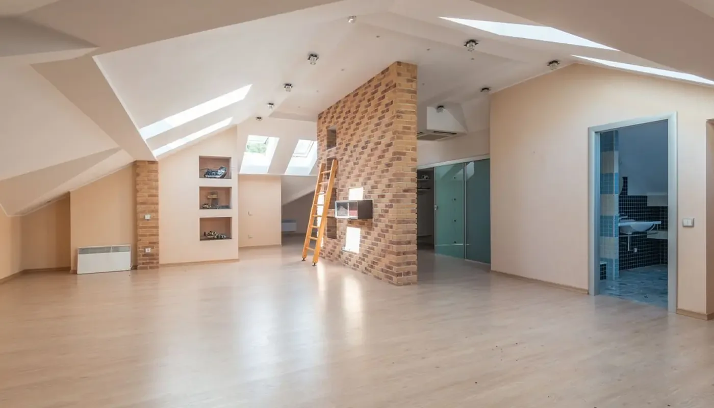 A bright open plan flat with timber floors and exposed brick, the kind of interior an interim inspection records midway through a tenancy